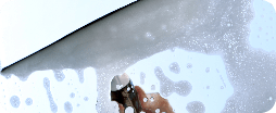 washing-window-with-soap-foam-closeup